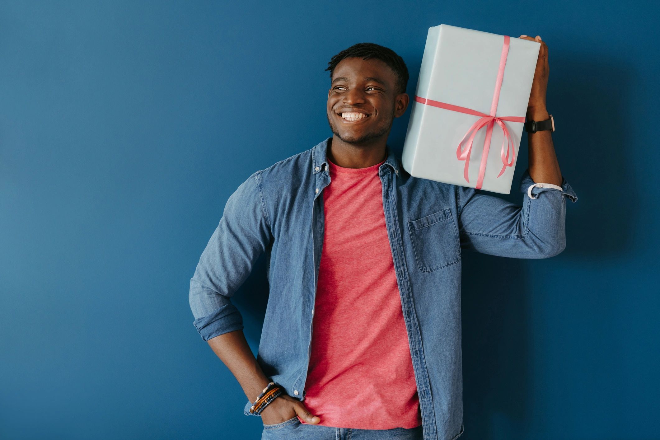 Smiling person holding a gift box